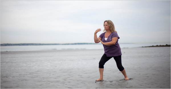 Mary Petersen, who has been suffering from Fibromyalgia, practicing tai chi on Nahant Beach, Mass., near her home. Credit: Jodi Hilton for The New York Times